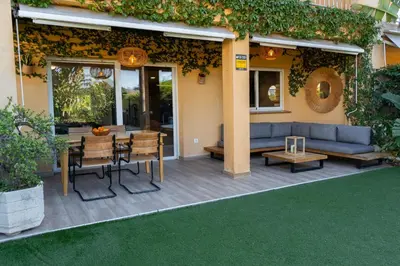 a bedroom with a bed and a glass wall at Villa Rocamar by Hello Homes Sitges in Sitges