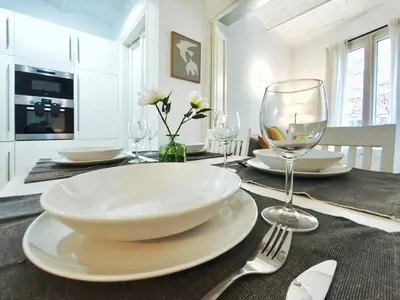 a dining room table with a plate and wine glasses at Apartamento turístico Muntaner Bonanova Sarrià in Barcelona