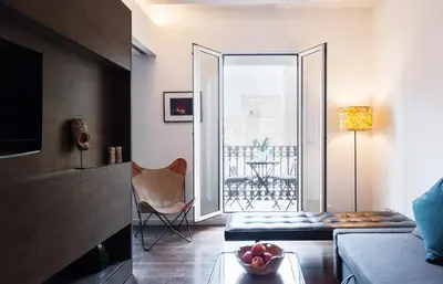 a living room with a couch a chair and a window at Design Apartment in Barcelona in Barcelona