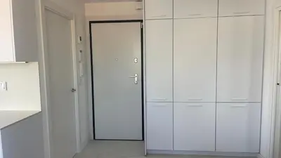 a white closet with white cabinets and a door at Ático premium Rambla Catalunya - Terraza 50 m2 in Barcelona