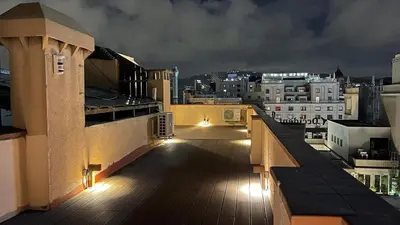 a balcony with a view of a city at night at Ático premium Rambla Catalunya - Terraza 50 m2 in Barcelona