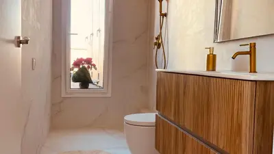 a bathroom with a toilet and a sink and a mirror at Ático premium Rambla Catalunya - Terraza 50 m2 in Barcelona