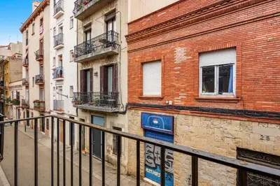 a glass door with a view of a building at Gràcia Loft Terrace BBQ AC & Fiber Wi-Fi in Barcelona