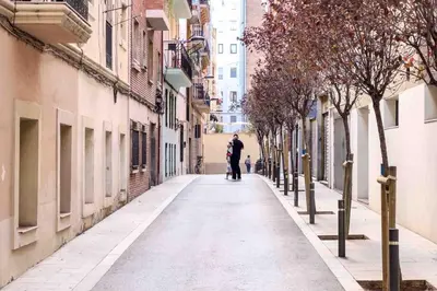 a man walking down a street in an alley at Central apartment in Barcelona in Barcelona
