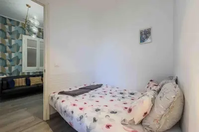 a small bed in a room with a mirror at Central apartment in Barcelona in Barcelona