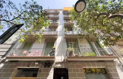 a building with a clock on the side of it at Central apartment in Barcelona in Barcelona