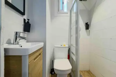 a bathroom with a white toilet and a sink at Central apartment in Barcelona in Barcelona