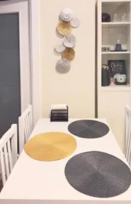 a dining room table with four mats on it at Entire Apartment in Barcelona, Camp Nou, Les Corts in Barcelona