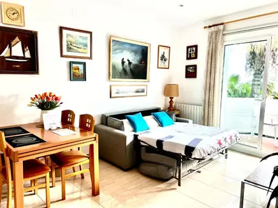 a living room with a couch and a table at Sitges Seafront RIBERA in Sitges