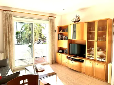 a living room with a large entertainment center with a television at Sitges Seafront RIBERA in Sitges