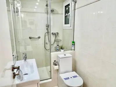 a bathroom with a shower and a toilet and a sink at Sitges Seafront RIBERA in Sitges