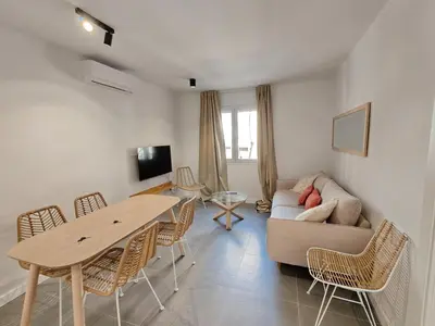 a living room with a table and a couch at Lovely apartment Poblenou beach in Barcelona
