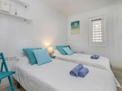 two beds in a room with blue pillows on them at Apartment Xaloc by Interhome in Cubelles