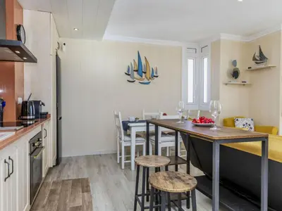 a kitchen and dining room with a table and chairs at Apartment Xaloc by Interhome in Cubelles