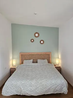 a bedroom with a large bed with two lamps at La Casa Delviga in Can Trabal