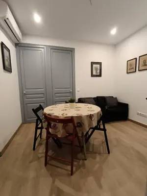 a living room with a table and a couch at Barcelona Eixample - Sagrada Familia - Monumental - City Center in Barcelona
