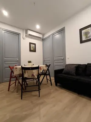 a living room with a couch and a table and chairs at Barcelona Eixample - Sagrada Familia - Monumental - City Center in Barcelona