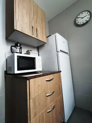 a kitchen with a microwave and a refrigerator at Barcelona Eixample - Sagrada Familia - Monumental - City Center in Barcelona