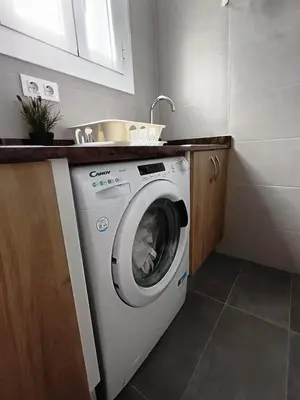 a washing machine in a kitchen with a sink at Barcelona Eixample - Sagrada Familia - Monumental - City Center in Barcelona
