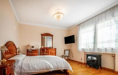 a bedroom with a bed and a fireplace and a television at Gorgeous Home In Arenys De Munt in Arenys de Munt
