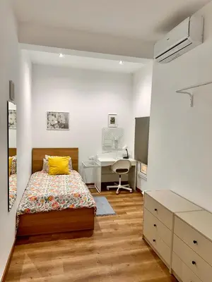 a white bedroom with a bed and a bathroom at Habitación 3 Metro Sant Antoni in Barcelona