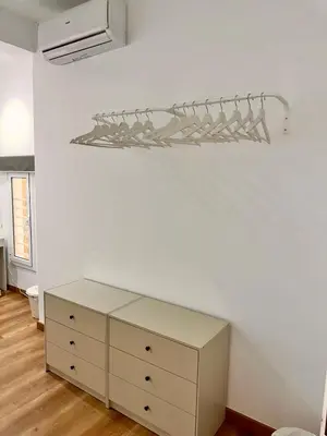 a bedroom with a bed and a dresser and a mirror at Habitación 3 Metro Sant Antoni in Barcelona
