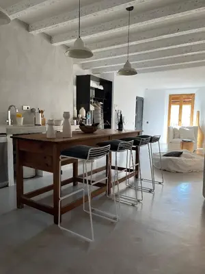 a kitchen with a large wooden table and chairs at Born penthouse loft 1 in Barcelona