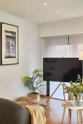 a living room with a large flat screen tv at BBarcelona Guinardó Park in Barcelona