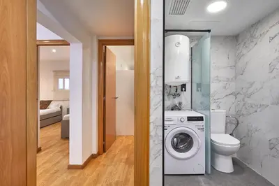 a bathroom with a washer and dryer in a room at BBarcelona Guinardó Park in Barcelona