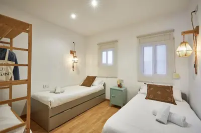 two beds in a room with two windows at BBarcelona Guinardó Park in Barcelona