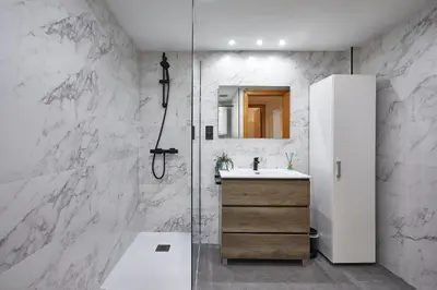 a white bathroom with a sink and a shower at BBarcelona Guinardó Park in Barcelona
