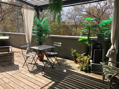 a patio with a table and chairs and plants at Apartamento Barcelona CCIB-Playa-Diagonal mar in Barcelona