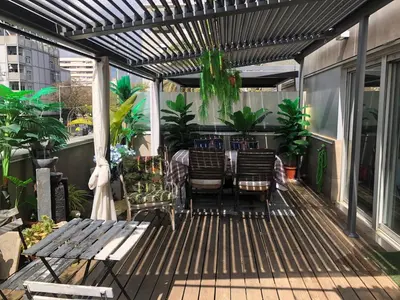 a patio with chairs and a table on a balcony at Apartamento Barcelona CCIB-Playa-Diagonal mar in Barcelona