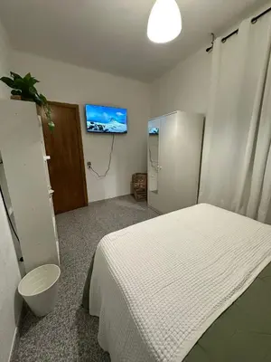 a bedroom with a bed and a tv on the wall at Mirian in Barcelona