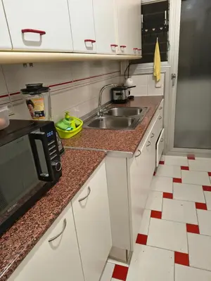 a kitchen with a sink and a microwave at Mirian in Barcelona