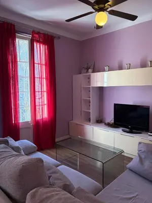 a living room with a couch and red curtains at Cozy Apartment in the Center Area Sagrada Familia in Barcelona