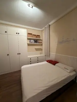 a bedroom with a white bed and white cabinets at Cozy Apartment in the Center Area Sagrada Familia in Barcelona