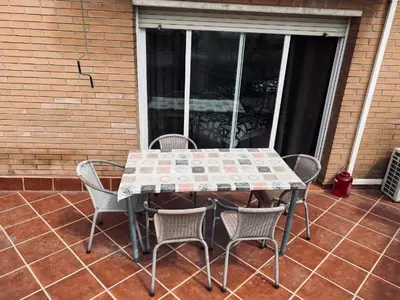 a table and chairs sitting on a patio at Habitaciones Carmen in Rubí