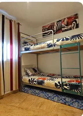 a room with two bunk beds and a flag at Estancia perfecta, apartamento bonito in Hospitalet de Llobregat