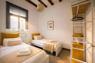 a bedroom with two beds and a window at Boutique Murillo in Barcelona