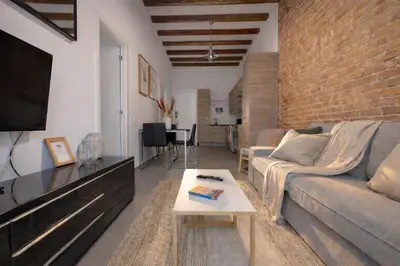 a living room with a couch and a table at Boutique Murillo in Barcelona