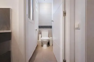 a small white bathroom with a toilet in it at Boutique Murillo in Barcelona