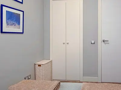 a bedroom with a white closet and a bed at Bonaire Penthouse Sitges 2 terraces steps from beach in Sitges