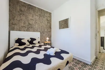 a bedroom with a bed and a window at Cozy apartment in bcn 3 bedrooms in Hospitalet de Llobregat