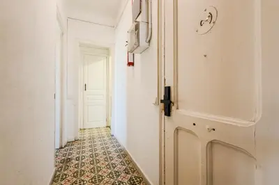 a small kitchen with a refrigerator and a sink at Cozy apartment in bcn 3 bedrooms in Hospitalet de Llobregat
