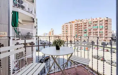 a table and chairs on the balcony of a building at Cozy apartment in bcn 3 bedrooms in Hospitalet de Llobregat