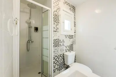 a bathroom with a white toilet and a sink at Cozy apartment in bcn 3 bedrooms in Hospitalet de Llobregat