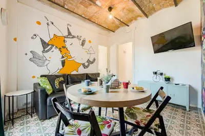 a living room with a couch and a tv at Cozy apartment in bcn 3 bedrooms in Hospitalet de Llobregat
