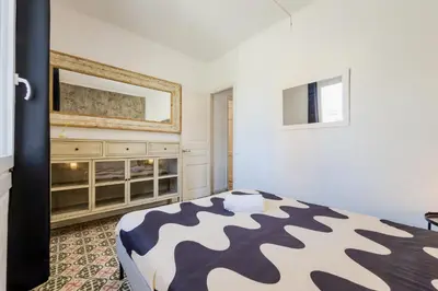 a bedroom with a bed in a room with a fan at Cozy apartment in bcn 3 bedrooms in Hospitalet de Llobregat