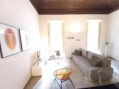 a living room with a couch and a chair at Catalan Music Palace with private terrace in Barcelona